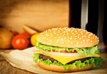 Delicious hamburger on brown paper on a wooden tabletop