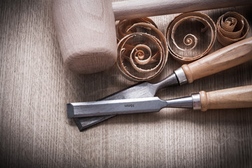 Wooden mallet scobs firmer chisels on wood surface horizontal vi
