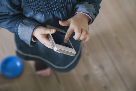 Toddler playing with mobile phone