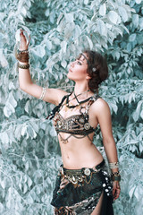 Pretty woman in tribal fusion costume near the beautiful white