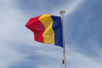 Flag of romania under blue sky