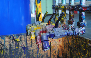 Cranes with CMYK paints at typography