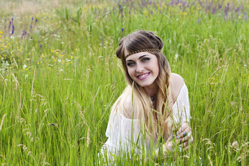 Beautiful hippie girl on the green meadow