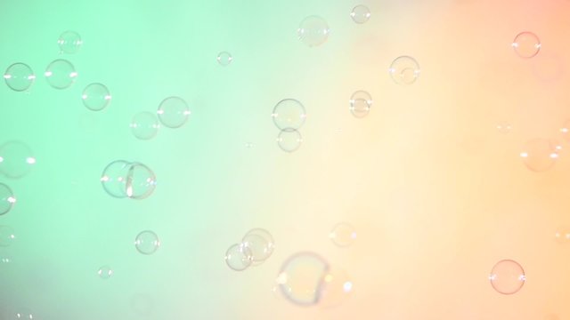 Blue and clear soap bubbles on turquoise and light pink