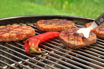 BBQ Hamburger Patties And Chili Pepper On The Hot Grill