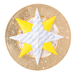 Handmade paper star made of music notes on a golden plate with snow isolated on white background - 88551802