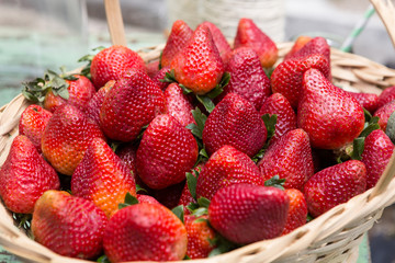 Sweet ripe strawberries in wicker basket