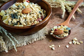 Rolgordijnen Oat and whole wheat grains flake in wooden bowl on wooden table © Kittiphan