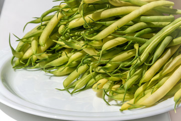 Black eyed pea pods on white plate