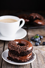 Chocolate donuts with coffee and blueberries