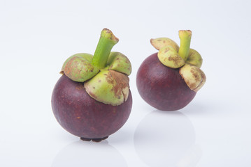 Mangosteen fruit and cross section showing the thick purple skin