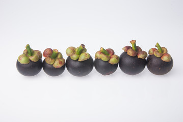 Mangosteen fruit and cross section showing the thick purple skin
