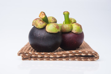 Mangosteen fruit and cross section showing the thick purple skin