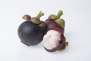 Mangosteen fruit and cross section showing the thick purple skin