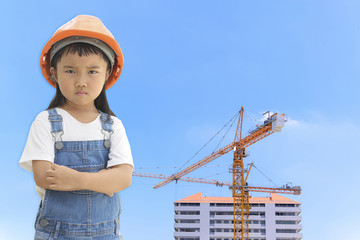Crane in construction site and kid engineer