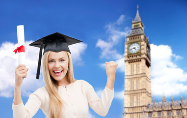student in trencher cap with diploma over big ben