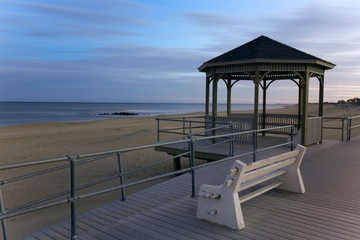 Quiet twilight view of a ocean shore and gazebo