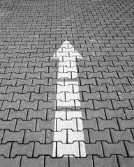 White arrow on the tiled floor