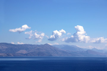 Fototapeta na wymiar Sea view. Mountain view. View on Albania mointains. Beautiful Ionian dark blue sea. Corfu. Kerkyra. Greece