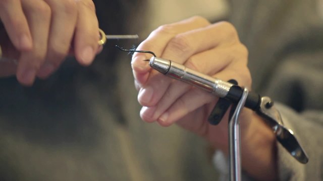 HD 1080 close up: fly tying specialist tying streamer fly; 