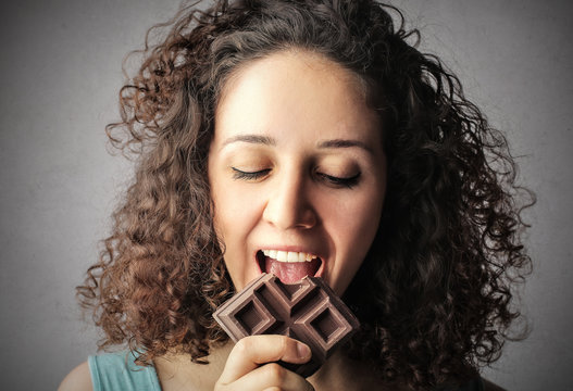 Young girl eating chocolate