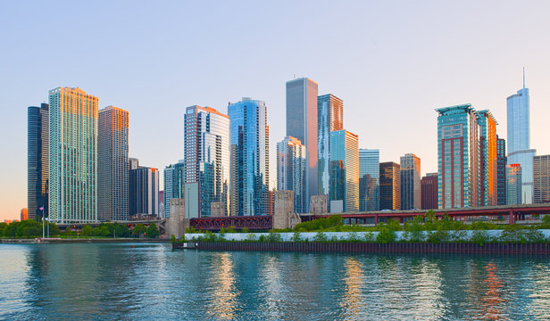 Chicago Illinois skyline at sunset with illuminated downtown buildings