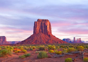 Foto auf Alu-Dibond Monument Valley in Utah and Arizona, sunrise or sunset with dramatic clouds, desert landscape of Navajo Nation Park is a famous travel destination for it's red rock formations © FotoMak
