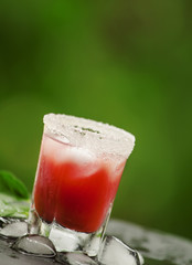 Red cocktail with ice and sugar, selective focus