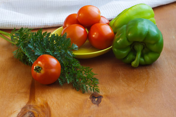 tomatoes and peppers on a wooden table