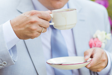 man's hands hold a cup of coffee 