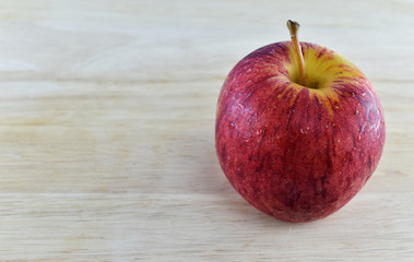 Red apple concept on wooden background