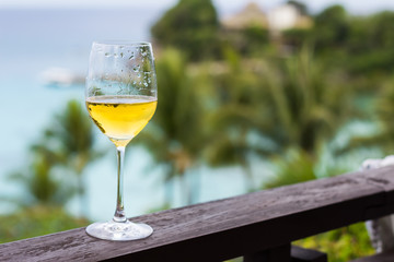 Glass of wine on balcony rail