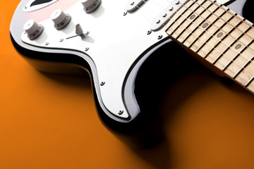 Electric guitar on orange background