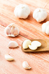 Organic garlic whole and cloves on the wooden background
