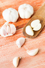 Organic garlic whole and cloves on the wooden background