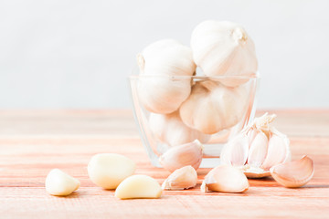 Organic garlic whole and cloves on the wooden background