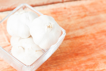 Organic garlic whole and cloves on the wooden background