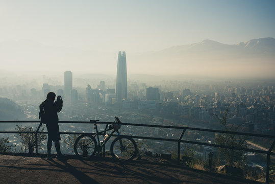 Sport photographer at the top of the hill. Santiago de Chile cityscape.