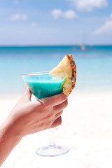 Blue Curacao cocktail in female hand