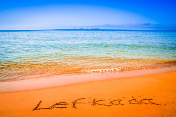 Lefkada written on sandy beach in Greece. Lefkada written on a sandy golden beach, Greece. Selective focus.