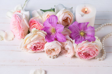 Roses and clematis   flowers and candle