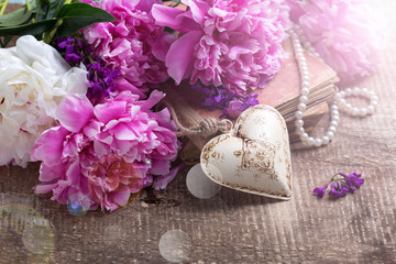 Decorative heart and splendid  pink  and white peonies flowers