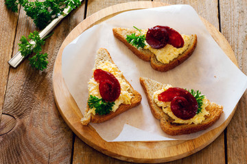 Bruschetta with cheese, garlic and jerked sausage on paper