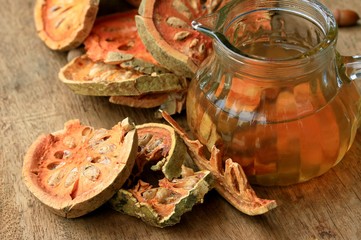 Slices of dried bael fruit and juice
