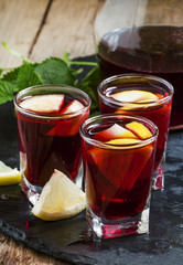 Red wine with lemon and orange, selective focus