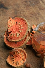 Slices of dried bael fruit and juice