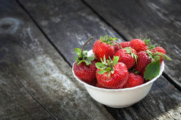 Ripe red strawberries on wooden table