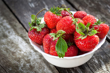 Ripe red strawberries on wooden table