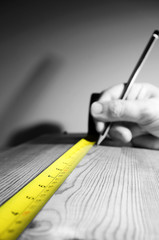 Tape measure wood.
Abstract image of a tape measure on a piece of wood.