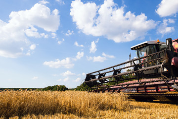 Photo of combine harvester that is harvesting wheat
